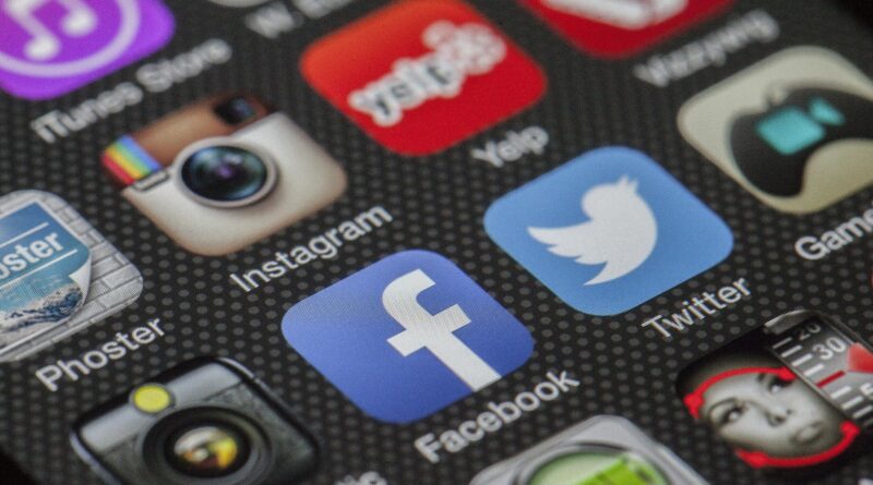 Close-up image of various social media app icons on a smartphone screen.